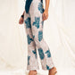 Printed high waist slim-fit trousers with slit at the hem