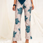 Printed high waist slim-fit trousers with slit at the hem